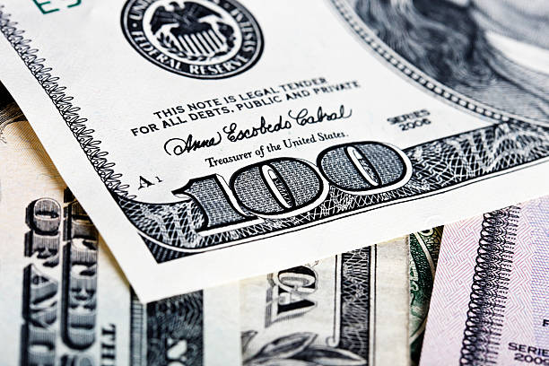 istock Extreme close up on a US $100 bill, others underneath 184621587
