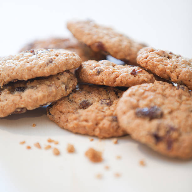 Homemade oatmeal cookie with raisins on a table with Christmas decorations.