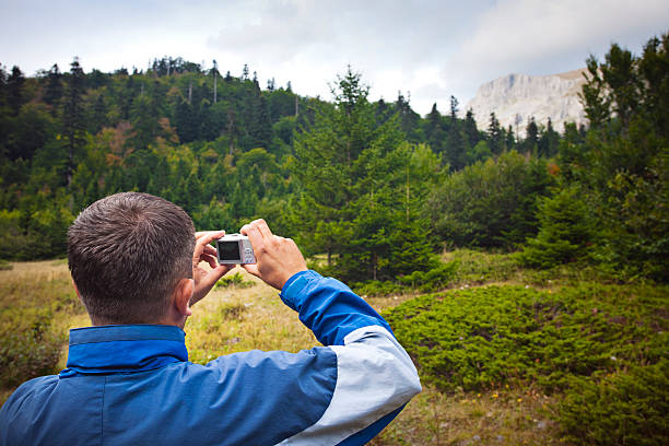 istock Hiker taking pictures in nature 184621697