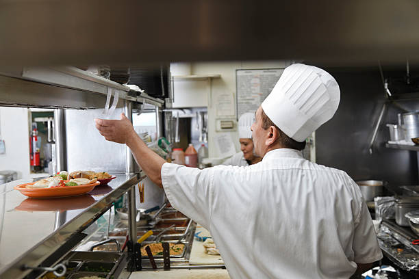 Cooks in Kitchen of Mexican Restaurant stock photo