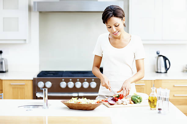 istock Smiling woman preparing salad 184622426