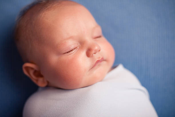 istock Color Image of Sleeping Baby Boy on Blue Background 184623214