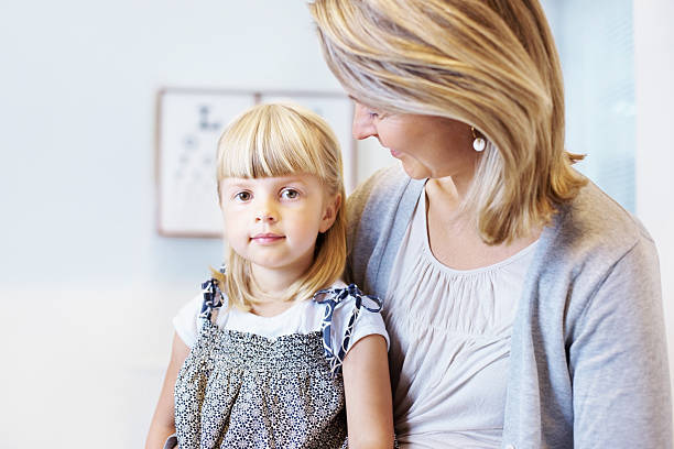 istock Mother and daughter in clinic 184623304