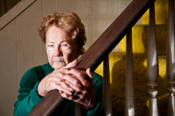 istock Senior woman sitting on staircase 184623359