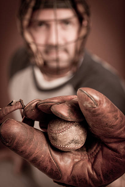 istock Vintage Baseball Player in Catching Stance with Ball and Mitt 184624059