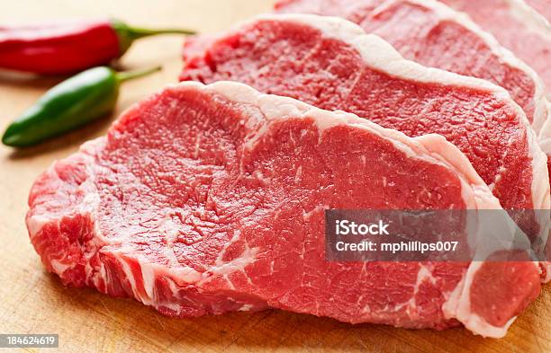 Slices Of New York Strip Steak On Cutting Board Stock Photo - Download Image Now - Meat, Beef, Raw Food