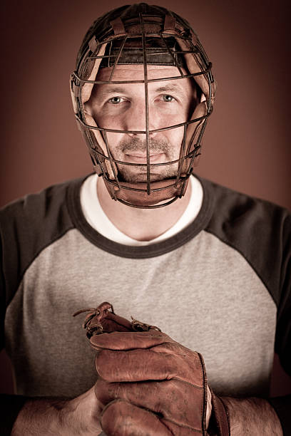 istock Vintage Baseball Player in Catching Stance Holding Mitt 184625323
