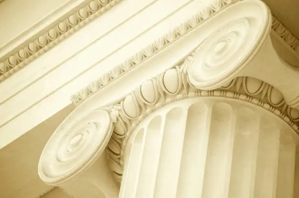 Close-up of scroll and pediment of pristine white marble fluted column
