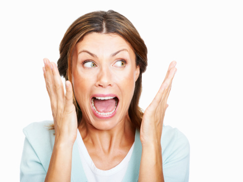 Closeup of shocked woman over white background