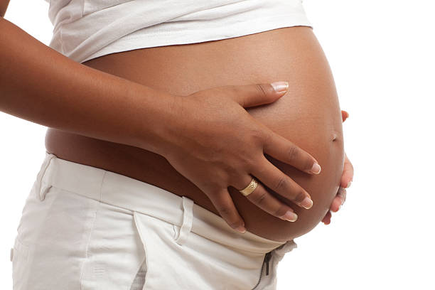istock woman stroking her pregnant  belly. 184625680