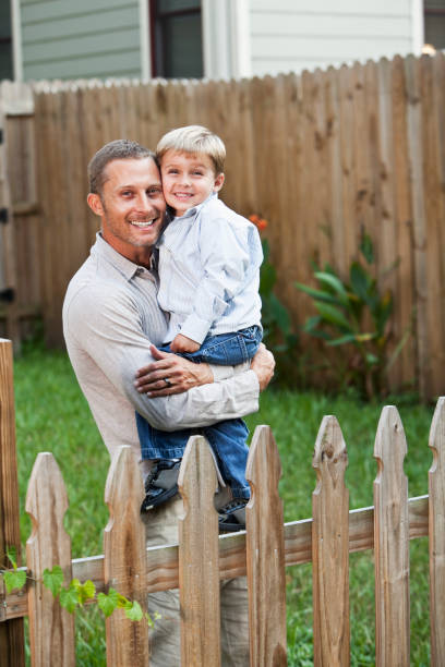 istock Father holding little boy in backyard 184626282