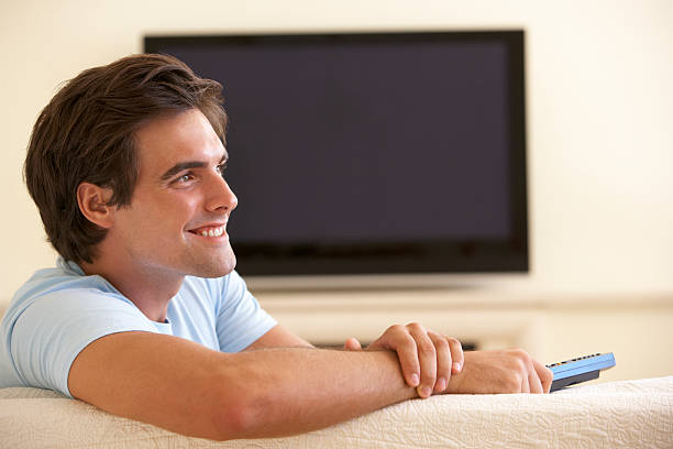 istock Man Watching Widescreen TV At Home 184626638