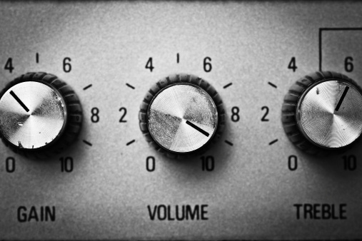 Volume knob to the max on a guitar amplifier. Black and white shot.