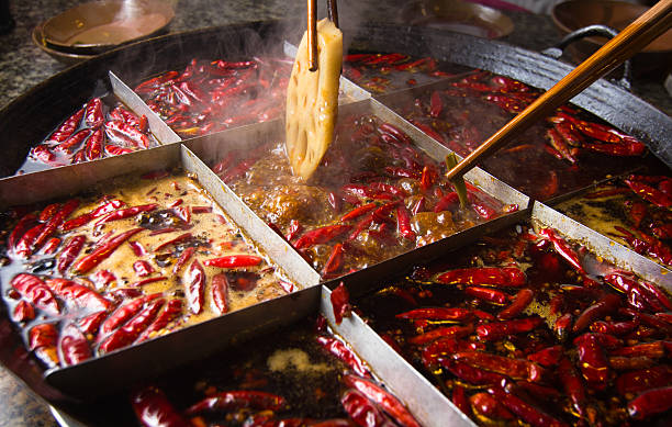 Large pot filled with hot peppers Famous Chongqing hot pot. It is one of spicy Chinese hot pot. sichuan province stock pictures, royalty-free photos & images