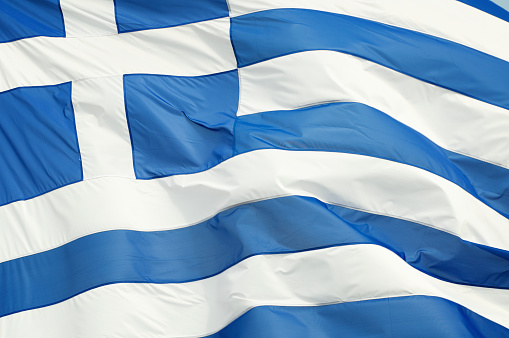 Greek flag close-up of flag of Greece waving outdoors full frame horizontal in bright sunlight