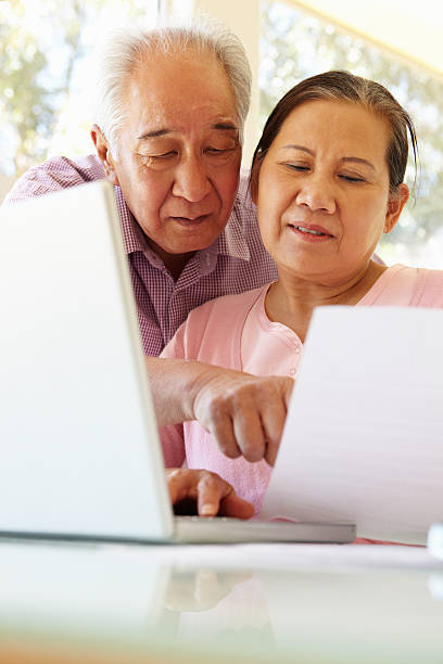 istock Senior Taiwanese couple working on laptop 184627231