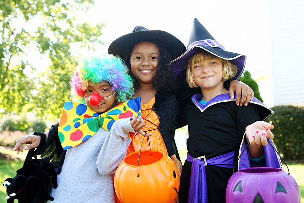 Halloween kids in costumes smiling stock photo