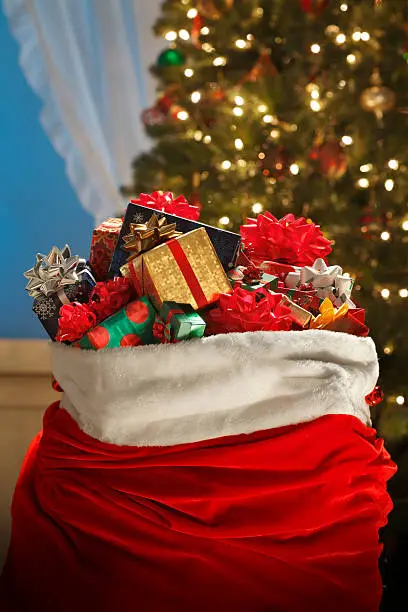 A Santa bag full of presents in front of a Christmas Tree on Christmas Eve.To see more holiday images click on the link below: