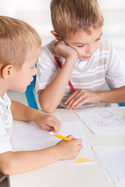 istock Two Little Boys Drawing Together 184627945