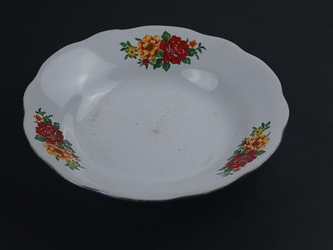Handmade porcelain empty plate on white background.