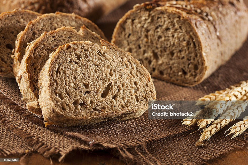 Fresh Homemade Whole Wheat Bread Fresh Homemade Whole Wheat Bread on a Background Baguette Stock Photo