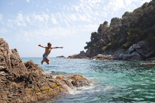 Young boy diving into the Mediterranean sea, Catalonia, Spain