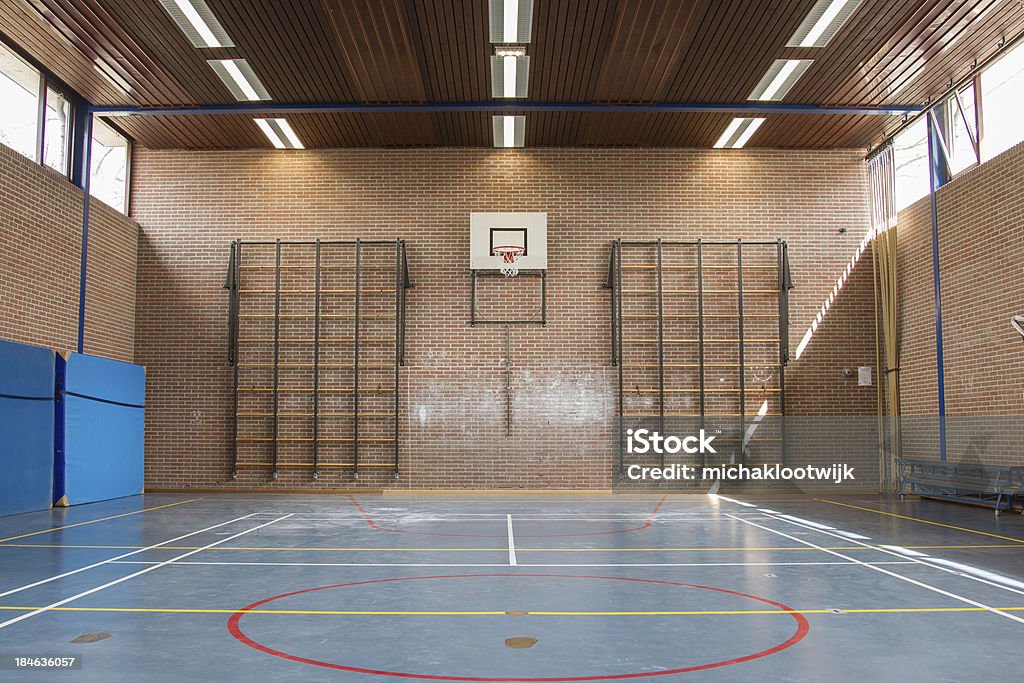 Interior of a gym at school Interior of a gym at school, jumping high at the basket School Gymnasium Stock Photo