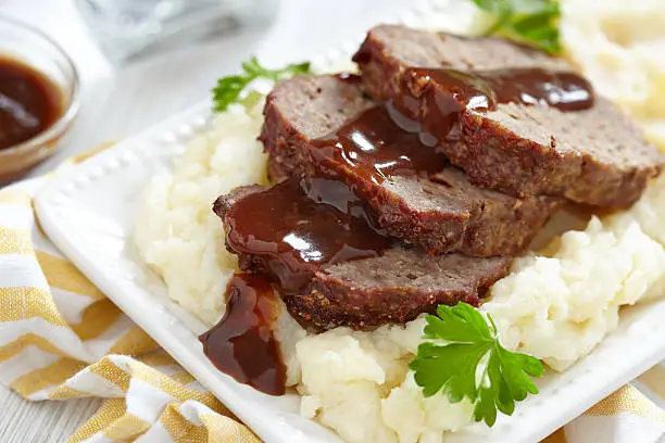 Meatloaf with brown sauce on mashed potato