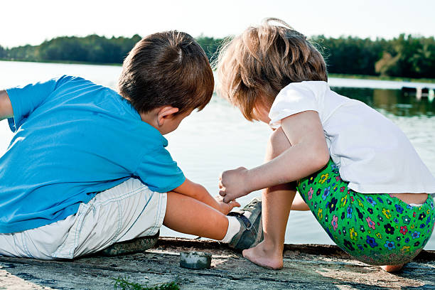 istock Little children playing on riverside. 184636612
