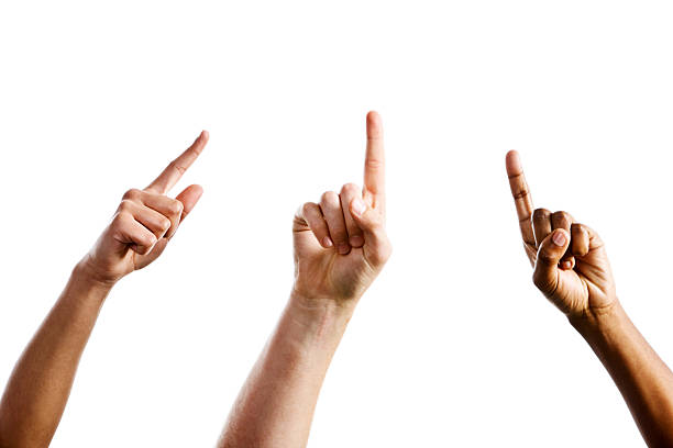 Three mixed hands point upward towards same unseen object "Three hands, one male and two female, point upwards, angled towards a single, unseen object.. Isolated on white." index finger stock pictures, royalty-free photos & images
