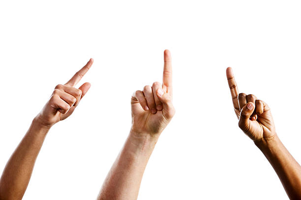 Three mixed hands point upward towards same unseen object "Three hands, one male and two female, point upwards, angled towards a single, unseen object.. Isolated on white." hand pointing stock pictures, royalty-free photos & images