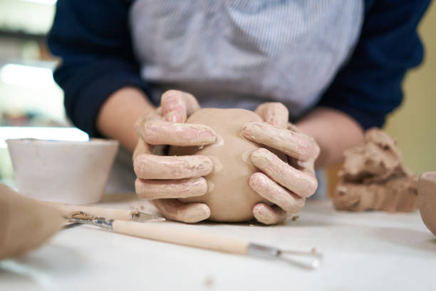istock woman forming clay pot shape by hands, closeup in artistic studio 1846367062