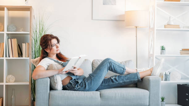 istock Enjoying reading inspired woman home relax room 1846367829
