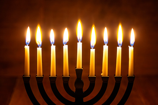Hanukkah Menorah Candle on a retro wood background