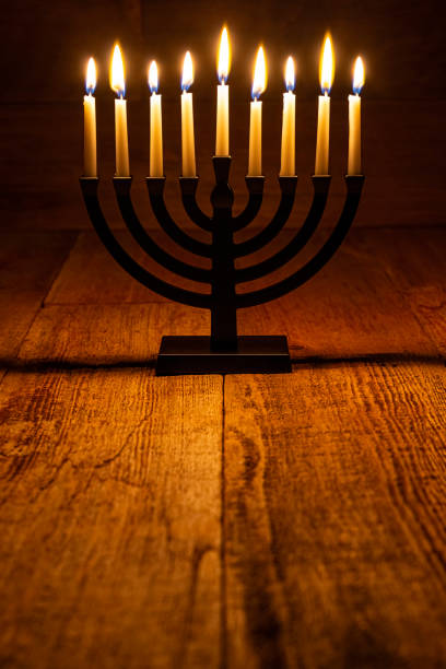 istock Hanukkah Menorah Candle on a retro wood background 1846368418