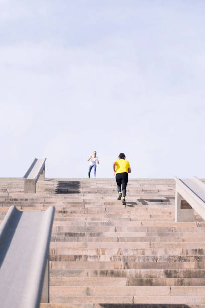 istock sports senior man training on stairs with trainer 1846368660