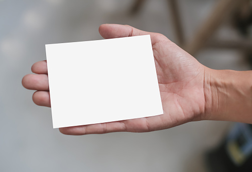 Close-up shot of Unrecognizable Hand Holding an Empty White Paper Card