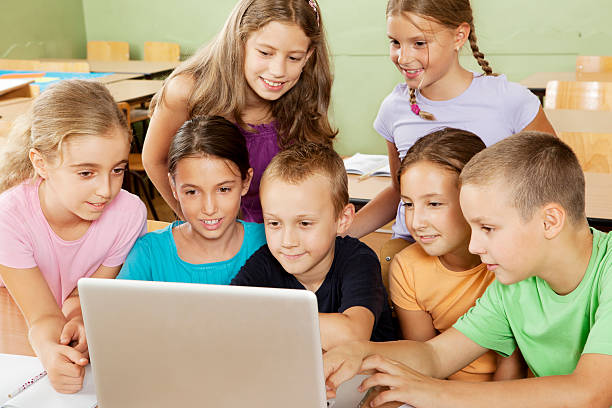 istock Cute Little School Children having class with laptop 184637836