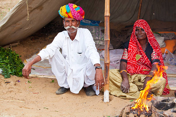 istock Old Indian couple by fire at Pushkar camel fair, India. 184638247