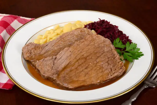 "Sauerbraten, a traditional German dish of marinated beef, served with spaetzle and red cabbage.Another image from this series:"