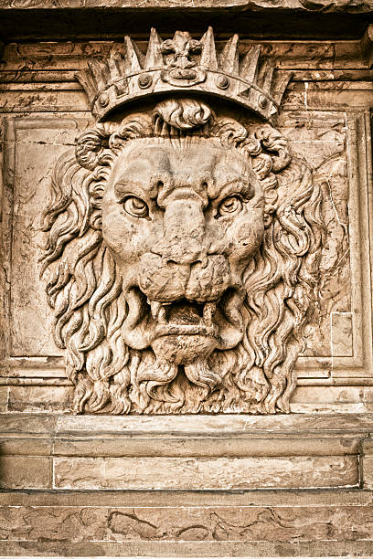 Old Lion face in stone on the external wall of Palazzo Pitti in Florence