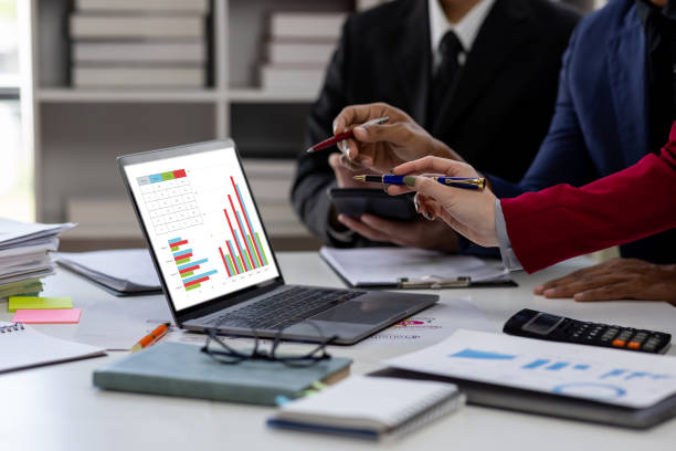 istock Confident business people point to graphs and charts to analyze marketing data graph chart document, balance sheet, account, net profit to plan new sales strategies to increase production capacity. 1846385722