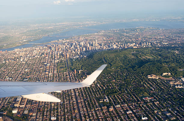 Airplane approaching the city of Montreal on a hazy day in summer ,Province of Quebec,Canada. The St Lawrence River in the background.
