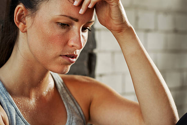 istock Intense young woman sweating after working out 184638657