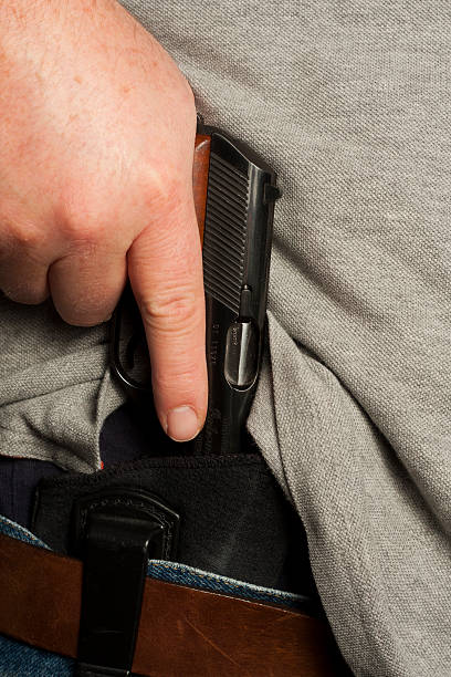 istock Concealed Carry Firearm Drawn From an Inside-the-Waistband Holster 184638725