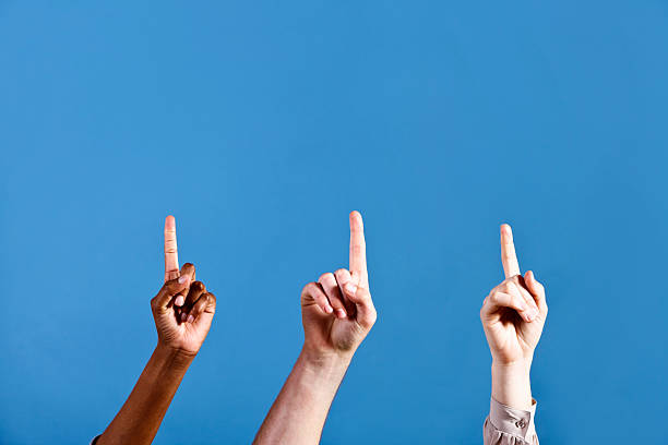 istock Three hands pointing up to a blue heaven 184638762