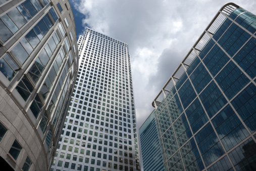business buildings against cloudy sky, Canada Tower or One Canada Square in the middle, Docklands, Canary Wharf, London, UK,