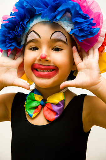 Little girl dressed as a clown.