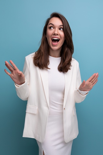 happy incendiary brunette young woman in white dress won the beauty contest.