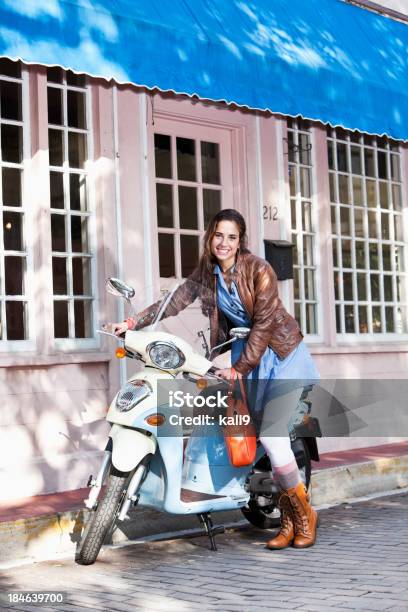 Young Woman With Scooter Outside Pastry Shop Stock Photo - Download Image Now - Motorcycle, Teenage Girls, Moped